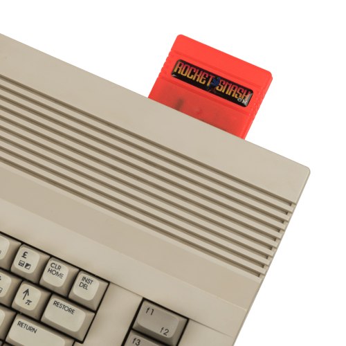 The orange Rocket Smash EX cartridge plugged into a Commodore 64