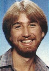 Douglas E. Smith in the mid-1980s: young, bearded, smiling at the camera