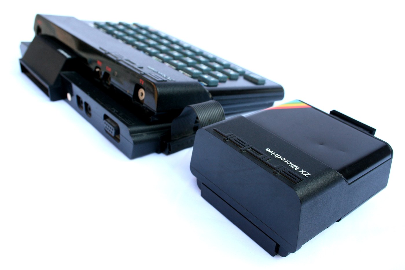 A ZX Spectrum with Interface 1 attached and a ZX Microdrive beside it