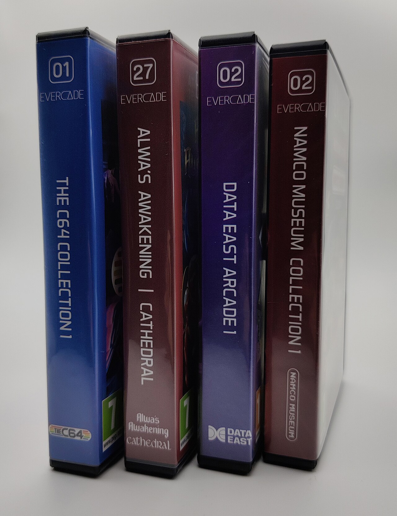 Four boxed Evercade cartridges lined up, showing the platform's physical cartridge packaging