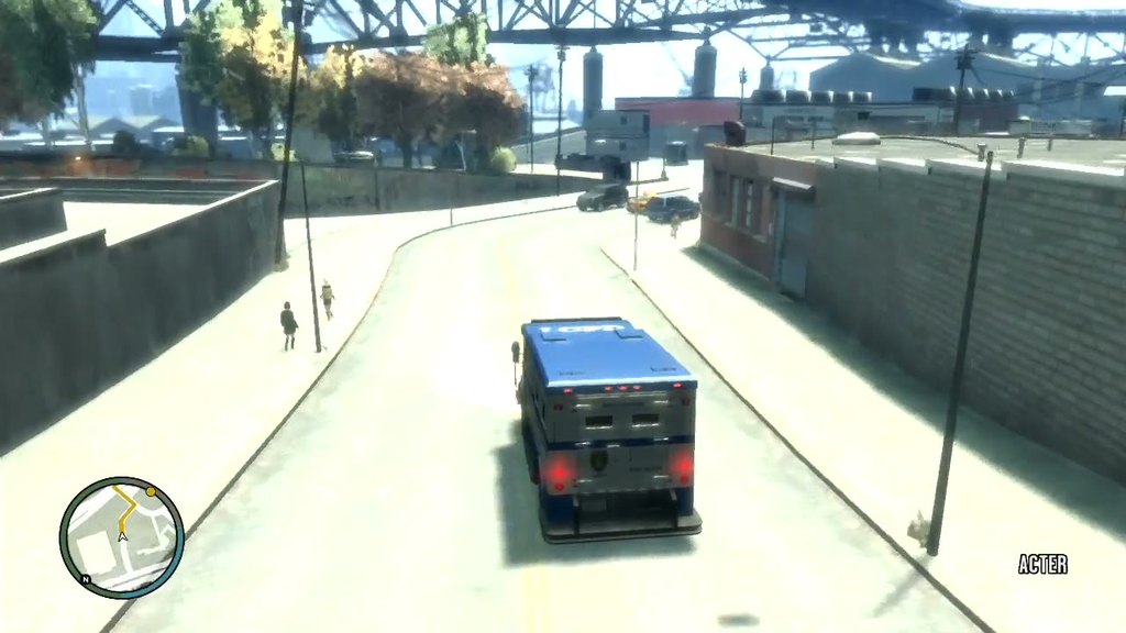 Grand Theft Auto IV on Xbox 360, an armoured truck rolling through industrial Acter, Alderney