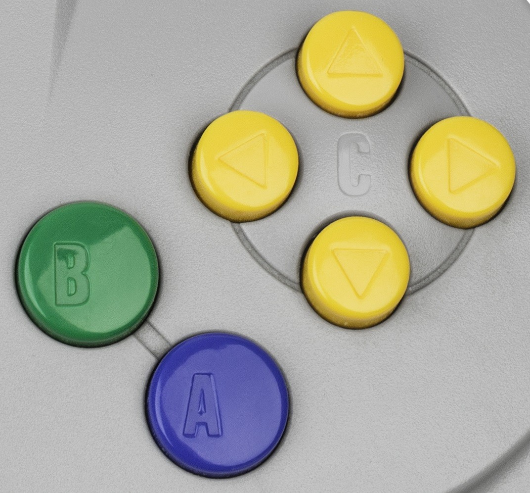 Close-up of the Nintendo 64 controller’s analog stick and face buttons.