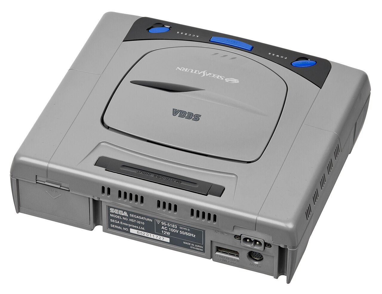 A Japanese Sega Saturn console photographed from above, showing the round disc lid, cartridge slot and rear expansion bay