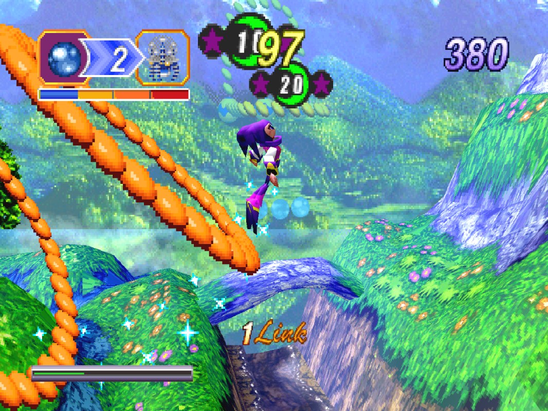 NiGHTS into Dreams gameplay screenshot, NiGHTS soaring through the green hills of Spring Valley collecting blue chips