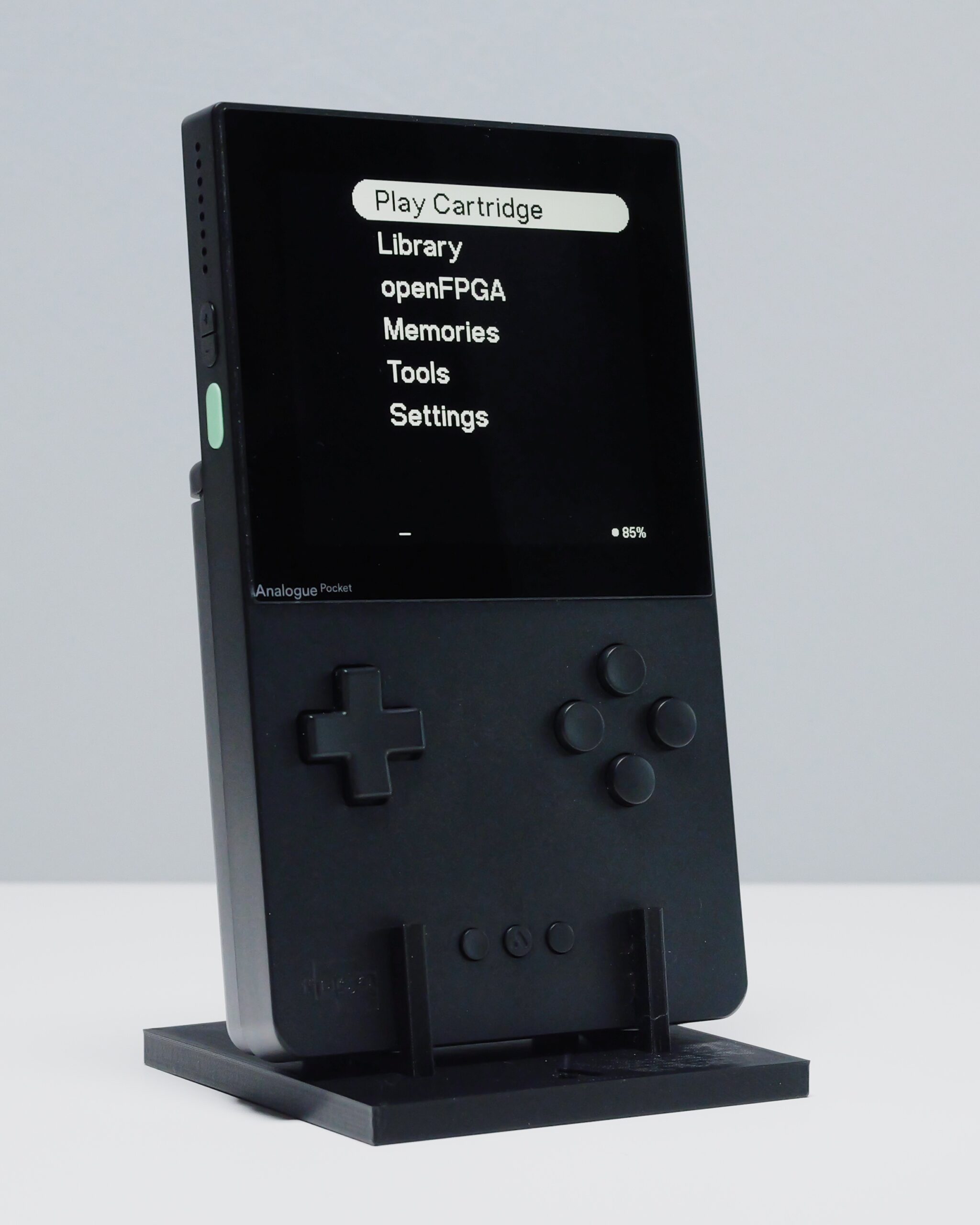 A black Analogue Pocket on a stand, its screen showing the openFPGA menu