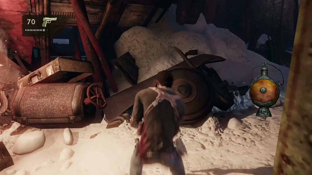 Uncharted 2 on PS3: Drake picking through the snowy train wreck, pistol ammo on the HUD