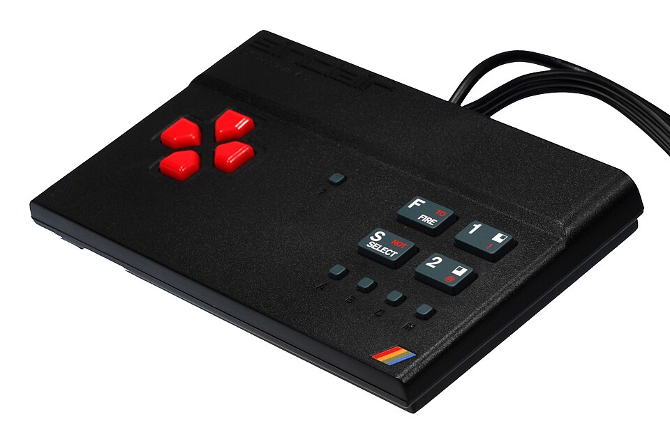 The original 2015 Vega: a TV plug-and-play wedge with a red D-pad and 1,000 games inside. It shipped, it worked, and it made the Vega+ pitch believable.